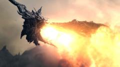 Fond ecran jeu video image synthese dragon ancestral crache feu flammes en volant colere fond montagnes nuages