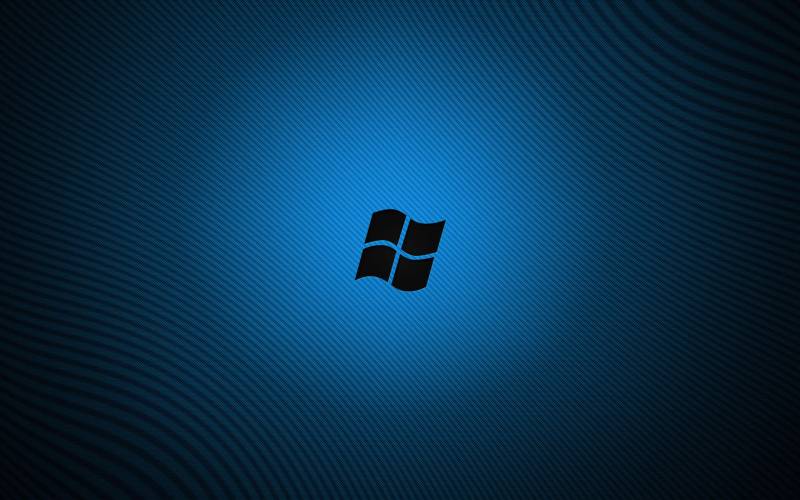 Windows seven fond ecran windows 7 ombre logo sur fond bleu lignes bleus sombres.